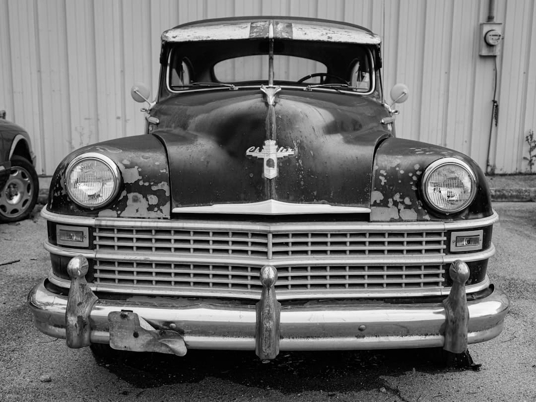 A vintage, classic car is shown in black and white.